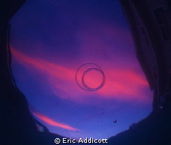 Sunset with bubble rings from the bottom of my pool. by Eric Addicott 